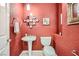 Stylish powder room with pedestal sink and decorative wallpaper at 11540 Snow Creek Ave, Las Vegas, NV 89135