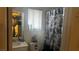 Bathroom featuring floral shower curtain, mirror, and window at 1653 Crystal Shadows Cir, Las Vegas, NV 89119