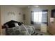 Bedroom featuring stylish bedding, window, and dresser at 1653 Crystal Shadows Cir, Las Vegas, NV 89119