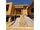 Exterior view of a new construction home featuring a sloped yard and a wooden staircase at 1764 Amarone Way, Henderson, NV 89012