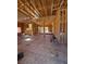 Unfinished living room with exposed wooden beams and plywood subfloors presents a spacious, customizable area at 1764 Amarone Way, Henderson, NV 89012