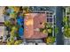 An aerial view shows the home's tile roof and backyard oasis featuring a pool and several blue umbrellas at 2355 Villandry Ct, Henderson, NV 89074