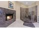 Bathroom featuring tile floors, a glass enclosed shower, and a stone surround fireplace at 2355 Villandry Ct, Henderson, NV 89074