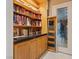 Built-in bookshelf with cabinet storage and black countertop next to glass paneled door at 2355 Villandry Ct, Henderson, NV 89074
