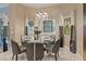 Dining area features a chandelier, modern curtains, and a picturesque view at 2355 Villandry Ct, Henderson, NV 89074