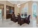 Formal dining room with marble floors, large windows, and built-in cabinets at 2355 Villandry Ct, Henderson, NV 89074
