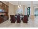 Formal dining room features built-in cabinets, elegant lighting, and a large window view at 2355 Villandry Ct, Henderson, NV 89074