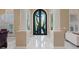 Elegant foyer featuring custom front door and tile floors at 2355 Villandry Ct, Henderson, NV 89074