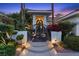 Close up of the front entrance with an artistic gate and landscaped surroundings at 2355 Villandry Ct, Henderson, NV 89074
