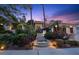 Elegant home featuring lush landscaping, mature trees, and inviting walkway leading to the front entrance at 2355 Villandry Ct, Henderson, NV 89074
