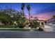 Charming home with palm trees, mature trees, and a walkway leading to the front entrance and driveway at 2355 Villandry Ct, Henderson, NV 89074