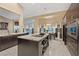 Gourmet kitchen with stone counters, modern appliances, and a center island at 2355 Villandry Ct, Henderson, NV 89074
