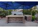 Outdoor kitchen with stone accents and a built-in grill area at 2355 Villandry Ct, Henderson, NV 89074