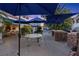 Tranquil backyard features a stone outdoor kitchen, fireplace and comfortable seating for outdoor relaxation at 2355 Villandry Ct, Henderson, NV 89074