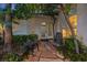 Inviting front patio area with stone pavers, seating, and lush landscaping at 2355 Villandry Ct, Henderson, NV 89074