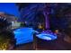 Stunning pool and spa area illuminated at night at 2355 Villandry Ct, Henderson, NV 89074