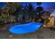Wide view of the backyard pool and landscaping at twilight at 2355 Villandry Ct, Henderson, NV 89074