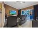 Home theater featuring leather recliners with a sliding glass door to the pool at 2355 Villandry Ct, Henderson, NV 89074