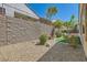 Backyard featuring a retaining wall and gravel landscaping at 2534 Starlight Valley St, Henderson, NV 89044