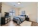 Comfortable bedroom featuring wood floors, a cozy bed, and a functional storage unit at 2534 Starlight Valley St, Henderson, NV 89044