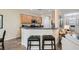 Kitchen with dark countertops and seating, opening up to the living room at 2534 Starlight Valley St, Henderson, NV 89044