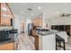 Open-concept kitchen featuring granite countertops, stainless steel appliances, and breakfast bar seating at 2534 Starlight Valley St, Henderson, NV 89044