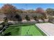 Beautiful backyard featuring a putting green, paver patio, brick wall, and mountain views at 257 Elder View Dr, Las Vegas, NV 89138