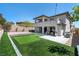 Stunning home backyard with putting green, patio area, outdoor furniture, and BBQ at 257 Elder View Dr, Las Vegas, NV 89138