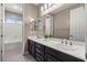Bathroom featuring dual sinks, dark cabinetry, and neutral color palette at 257 Elder View Dr, Las Vegas, NV 89138