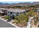 Two-story home featuring a tiled roof, landscaped yard, and neighborhood views in a sunny setting at 257 Elder View Dr, Las Vegas, NV 89138