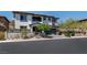 Two-story stucco home with a stone facade, well-maintained front yard, and driveway leading to a garage at 257 Elder View Dr, Las Vegas, NV 89138