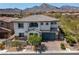 Charming two-story home features a well-manicured lawn, tiled roof, and mountain views at 257 Elder View Dr, Las Vegas, NV 89138