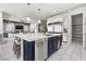 A modern kitchen featuring a large island with seating and open access to the living area at 257 Elder View Dr, Las Vegas, NV 89138
