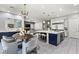 Open-concept kitchen featuring a large island, modern appliances, and dining area with stylish decor at 257 Elder View Dr, Las Vegas, NV 89138