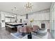 Open-concept kitchen and dining area with stainless steel appliances, a large island, and modern lighting at 257 Elder View Dr, Las Vegas, NV 89138