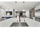 Spacious kitchen island with stainless steel sink, modern faucet, and pendant lighting above at 257 Elder View Dr, Las Vegas, NV 89138