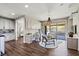Open-concept living space with built-in cabinets, desk, chandelier, and seamless access to the patio at 257 Elder View Dr, Las Vegas, NV 89138