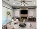 Cozy living room with a fireplace, media center, and sliding glass doors to the backyard at 257 Elder View Dr, Las Vegas, NV 89138