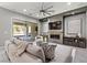 Comfortable living room with a fireplace, television, and sliding glass doors to the backyard at 257 Elder View Dr, Las Vegas, NV 89138