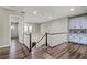 Bright staircase landing featuring wood floors, white railings, and built-in storage at 257 Elder View Dr, Las Vegas, NV 89138
