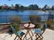 Outdoor patio with seating, providing relaxing views of the community's peaceful lake and lush landscaping at 2608 Port Of Call Dr, Las Vegas, NV 89128