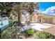 Scenic backyard featuring a spacious patio, mature trees, lush landscaping, and tranquil lake views at 2608 Port Of Call Dr, Las Vegas, NV 89128