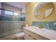 Neutral bathroom with large vanity, shower/tub combination and round mirror at 2608 Port Of Call Dr, Las Vegas, NV 89128