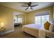 Cozy bedroom featuring mirrored closet doors, ceiling fan, and neutral decor at 2608 Port Of Call Dr, Las Vegas, NV 89128