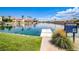 Picturesque community lake with clear water, lush greenery, a dock, and community signage at 2608 Port Of Call Dr, Las Vegas, NV 89128