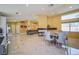 Open-concept living and dining area with lots of light, tile floors and neutral decor at 2608 Port Of Call Dr, Las Vegas, NV 89128