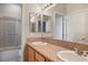 Bathroom featuring double sinks, granite countertops, and a shower-tub combination at 2622 Rimpacific Cir, Las Vegas, NV 89146