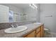 Bathroom featuring double sinks, granite countertops, and a shower-tub combination at 2622 Rimpacific Cir, Las Vegas, NV 89146