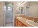 Bathroom featuring double sinks, granite counters, tile floor and shower/tub enclosure at 2622 Rimpacific Cir, Las Vegas, NV 89146