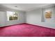 Spacious bedroom with plush red carpeting and bright natural light at 2622 Rimpacific Cir, Las Vegas, NV 89146